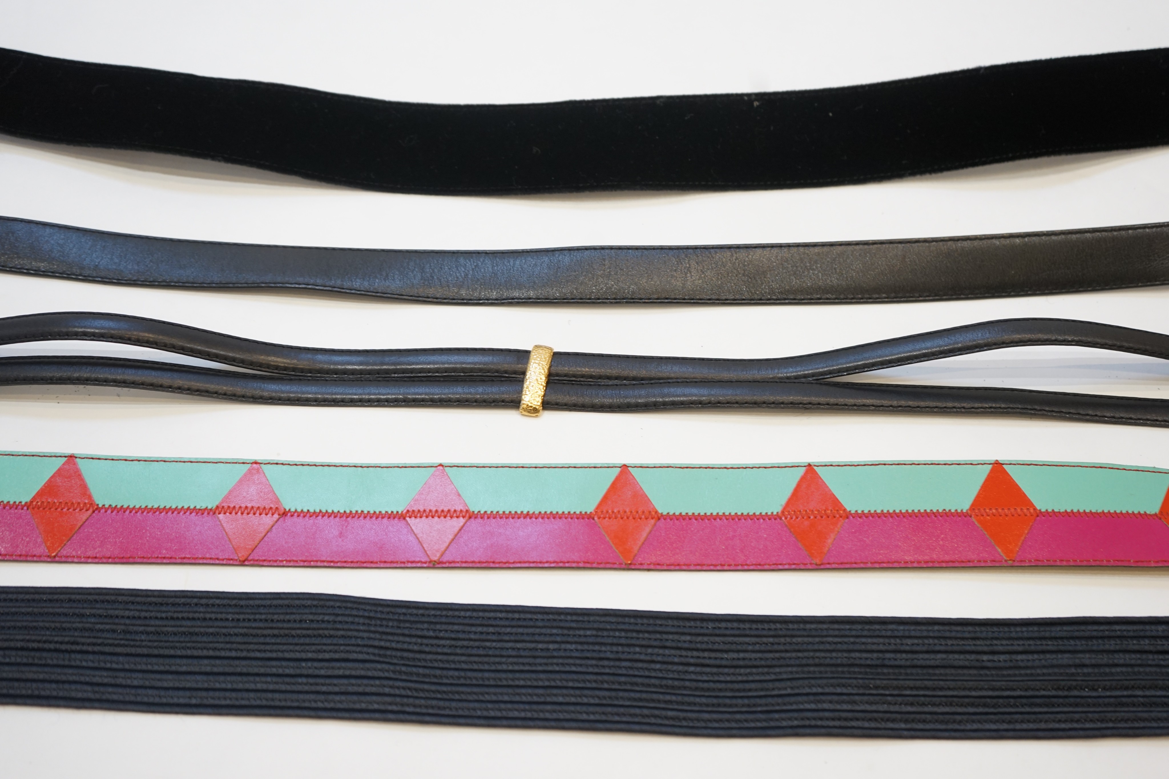 A collection of five Yves Saint Laurent belts
